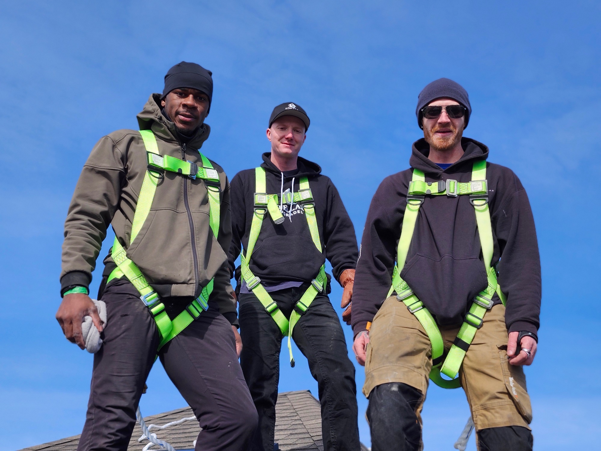 Stellar Upgrades electricians on roof in safety harnesses — Edmonton solar installation crew