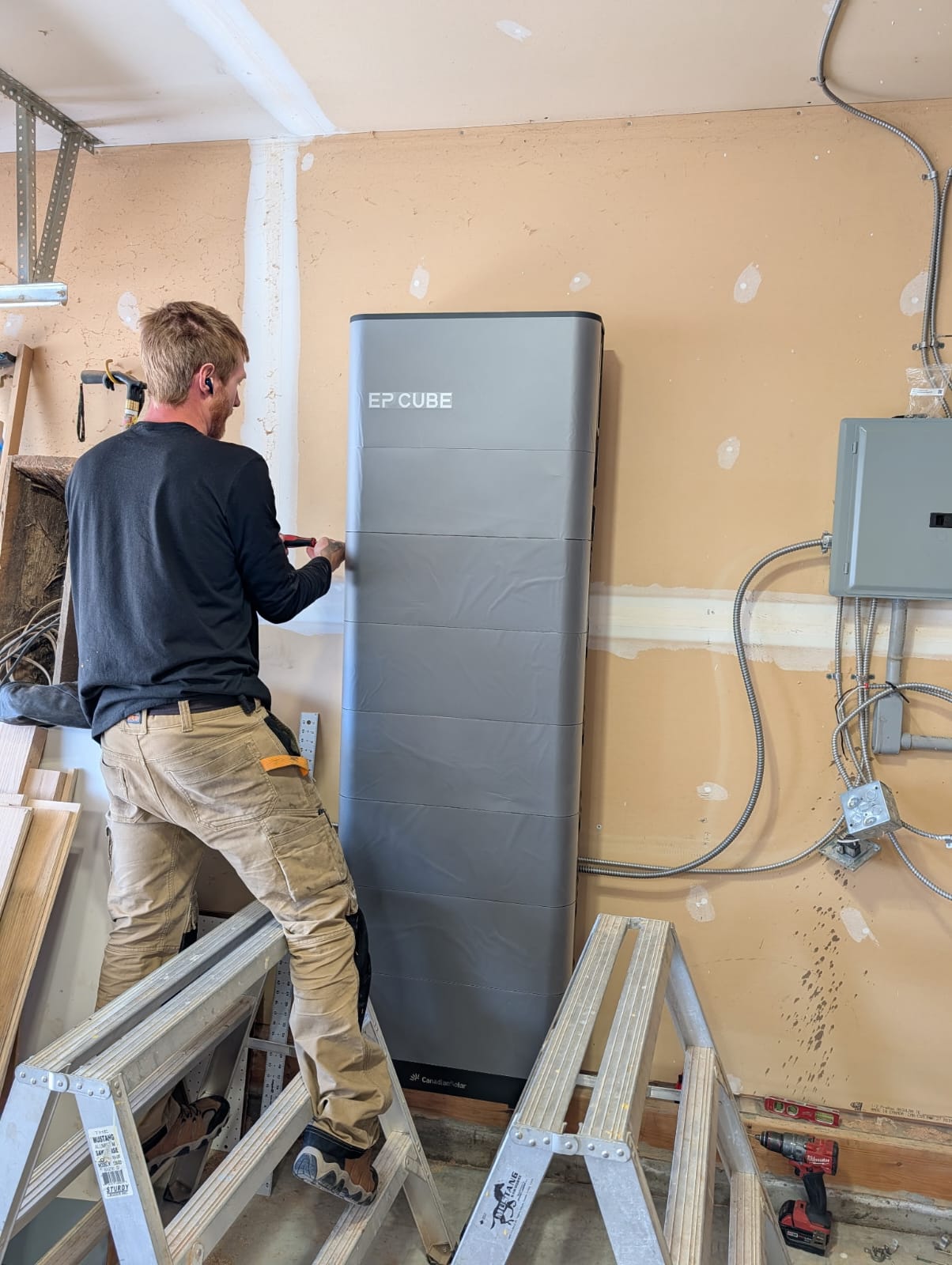 Stellar Upgrades crew installing Canadian Solar EP Cube battery backup system in a Sherwood Park, Alberta attached garage