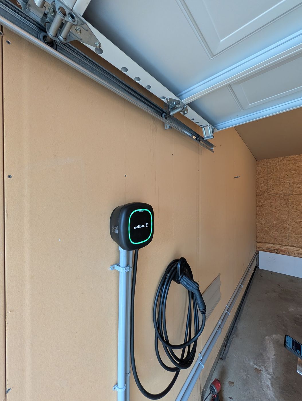 Level 2 Wallbox Pulsar Plus EV charger mounted on dedicated conduit pole in an Edmonton residential garage by Stellar Upgrades
