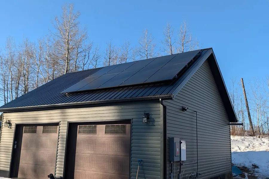 Jordan Walsh installing solar panels on Edmonton rooftop