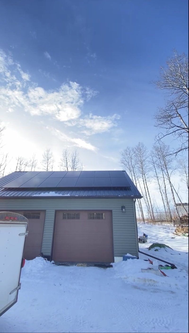 Metal-roof solar panel installation on a garage in winter, Alberta by Stellar Upgrades