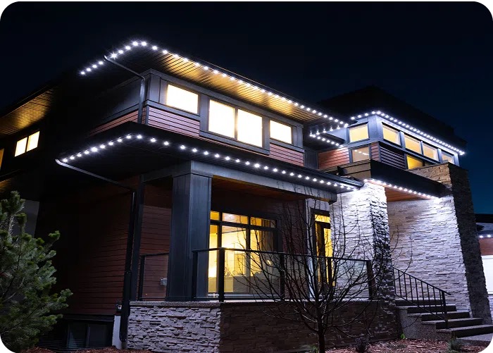 Modern Alberta home at night with permanent lighting along the fascia