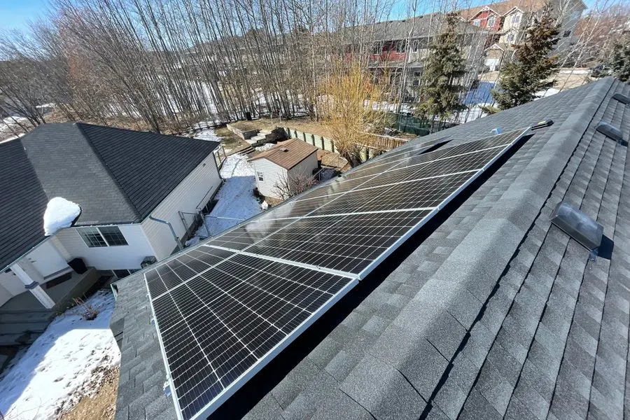 Rooftop solar panels shedding snow in Edmonton winter