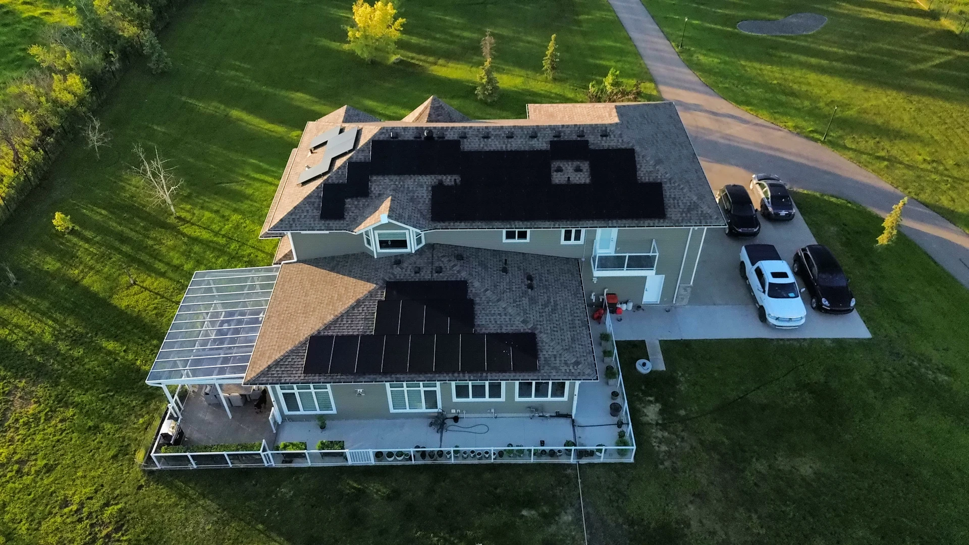 Aerial view of a country home with solar across multiple rooflines