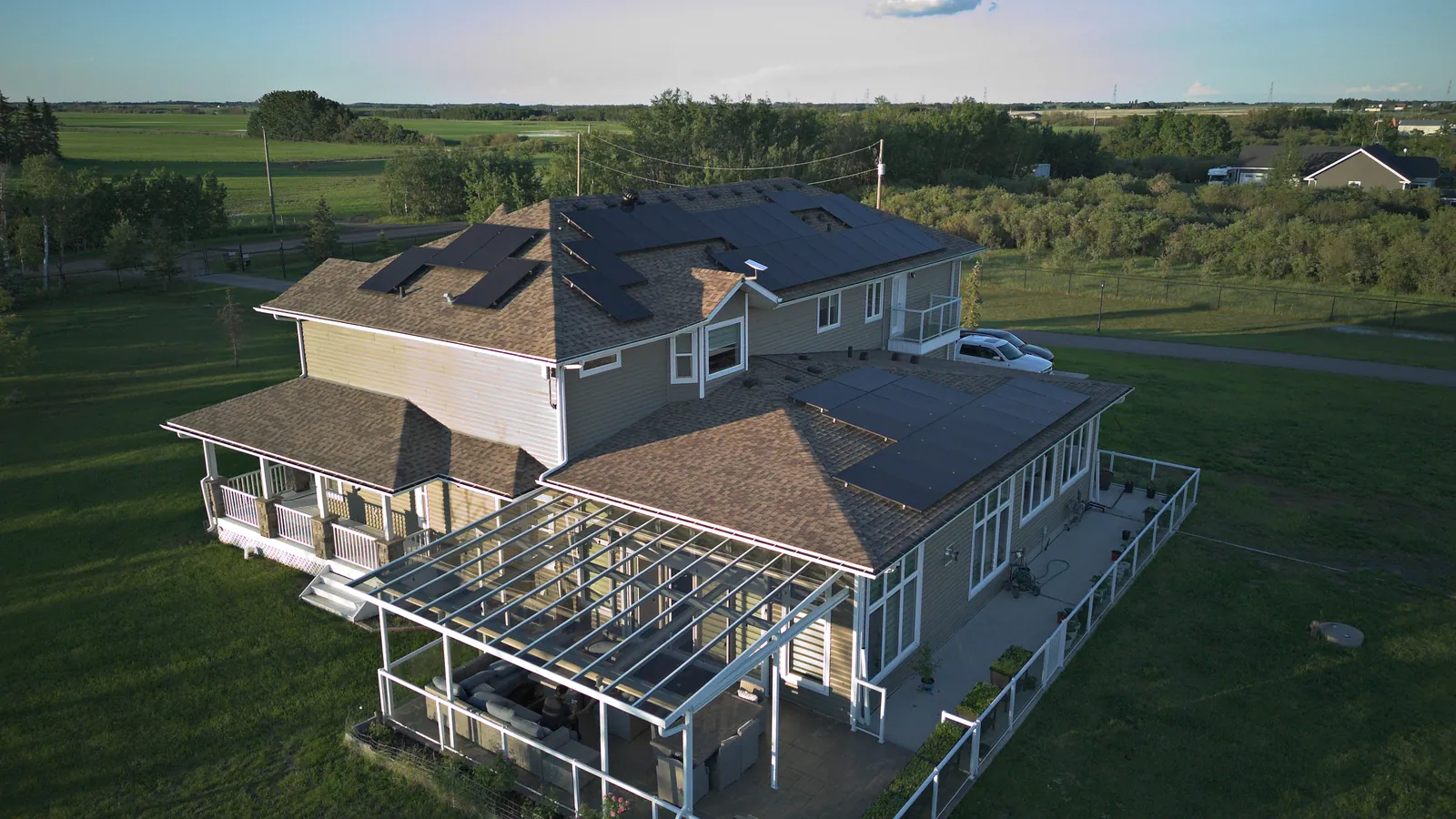 Aerial view of an Alberta acreage home near Edmonton with all-black solar panels installed on the roof by Stellar Upgrades